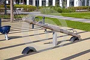 Children's playground with a safe rubber coating in the courtyard of a modern residential complex. Swings and other