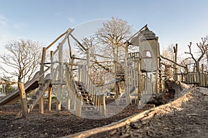 The Children\'s playground with Slide, Rope Net Bridge made of Wooden Tree trunk in acton park