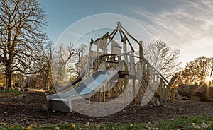 The Children\'s playground with Slide, Rope Net Bridge made of Wooden Tree trunk in acton park