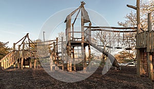 The Children\'s playground with Slide, Rope Net Bridge made of Wooden Tree trunk in acton park