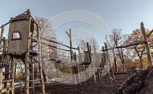 The Children\'s playground with Slide, Rope Net Bridge made of Wooden Tree trunk in acton park