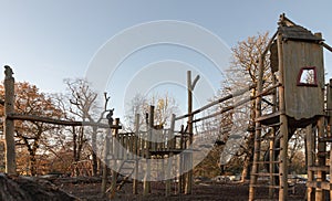 The Children\'s playground with Slide, Rope Net Bridge made of Wooden Tree trunk in acton park