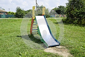 Children's playground. Swing, carousel and slide photo