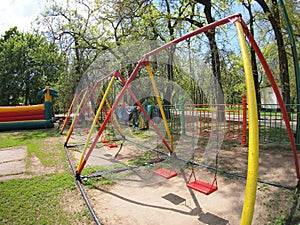 Children's playground with swings in the park