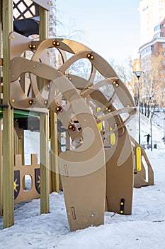 Children& x27;s playground in winter in the city. Children& x27;s slide, play equipment