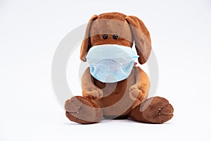 Children`s plush dog in a protective gauze bandage; flu epidemic