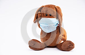 Children`s plush dog in a protective gauze bandage; flu epidemic