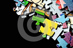 Children`s puzzles scattered on a dark background