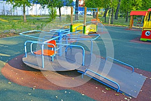 Children`s revolving carousel in the park, for children with disabilities. Russia photo