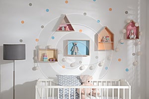 Children`s room with house shaped shelves and crib. Interior design