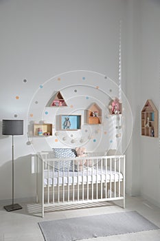 Children`s room with house shaped shelves and crib. Interior design