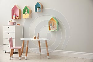 Children`s room with house shaped shelves and little table