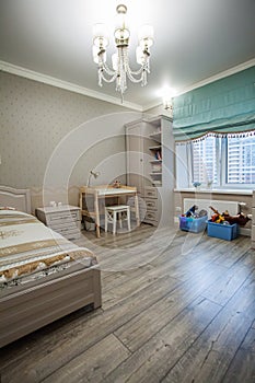 Children`s  room interior with wooden bed, table and wardrobe