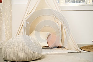 Children's room with play tent teepee and pillows close up