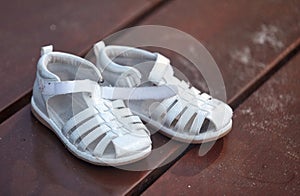 Children`s sandals on the boardwalk