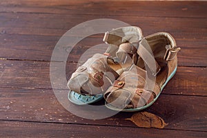 Children's sandals made of leather with a peeled sole. Old worn-out shoes
