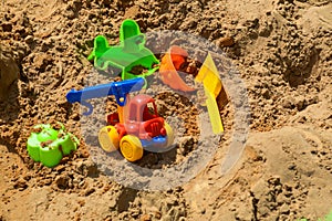 Children`s sandbox on the playground for games with toys for children by truck, car, excavator, sand dressers with a spatula