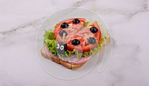 Children`s sandwich in the form of a ladybug. Children`s table setting. Children`s menu