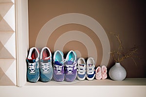 Children`s shoes next to an adult