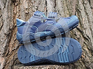 Children`s shoes on a wooden background