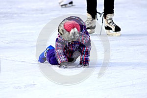 Children s skate ice rink. A little boy skates in winter. Active family sport. School sports clubs, entertainment for children on