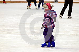 Children s skate rink. A little boy skates in the winter. Active family sport , the winter holidays and the cold season.School