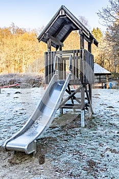 Children\'s slide on the playground in winter