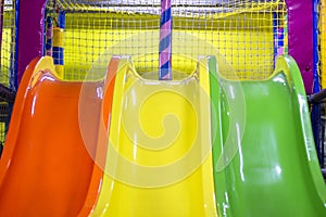Children\'s slides, an entertaining playground. Close-up. Children\'s slides orange, yellow