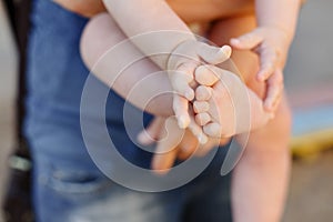 Children`s small handle and foot. Little baby fingers