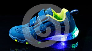 Children`s sneaker shoe with led light illumination