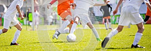 Children`s soccer drills. Kids kicking football match on pitch