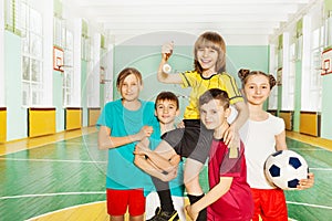 Children`s soccer team celebrating victory