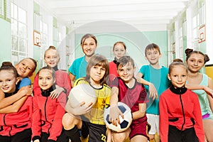 Children`s soccer team in school sports hall
