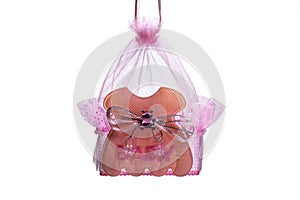 Children`s souvenir toy. Doll cradle. A small lullaby. Pink symbol of a newborn baby. Isolated on a white background. Object for