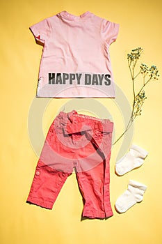 children's t-shirt with inscription: happy days and pants flat lay