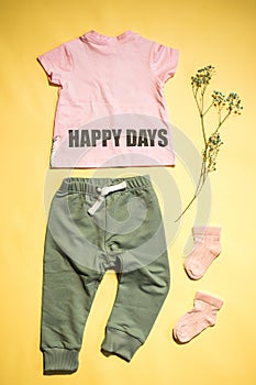 children's t-shirt with inscription: happy days and pants flat lay