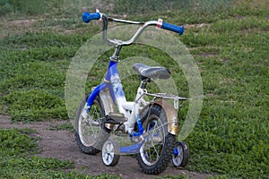 Children`s teenage bike blue on green lawn