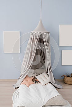 Children`s tent bed with pillows and toys. Frames on the wall mockups. Children`s room interior