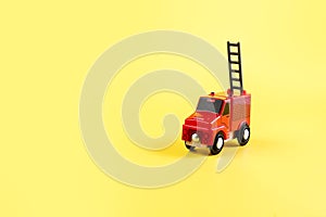 Children's toy, car on a yellow background. Fire engine. Concept. Isolate. Copy space.