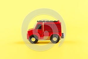 Children's toy, car on a yellow background. Fire engine. Concept. Isolate. Copy space.