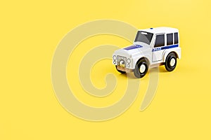 Children's toy, car on a yellow background. Police car. Concept. Isolate. Copy space.