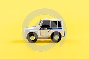 Children's toy, car on a yellow background. Police car. Concept. Isolate. Copy space.