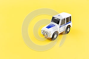 Children's toy, car on a yellow background. Police car. Concept. Isolate. Copy space.