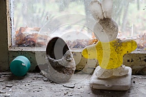 Children`s toy and shoes on windowsill in abandoned kindergarten in destroyed village of Kopachi Chernobyl NPP alienation zone