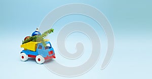 Children`s toy truck filled with Christmas tree decorations. New year concept. Machines and on a blue background