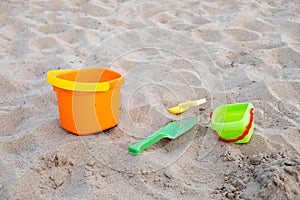 Children`s toys lie on the sand on the beach. Family vacation on the beach.