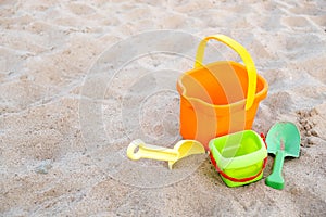 Children`s toys lie on the sand on the beach. Family vacation on the beach.