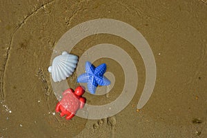 children\'s toys, molds for playing in the sand on the beach, by the sea. background for the design. summer holidays