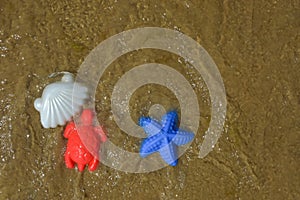 children\'s toys, molds for playing in the sand on the beach, by the sea. background for the design. summer holidays