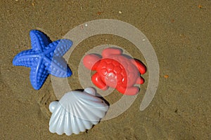 children\'s toys, molds for playing in the sand on the beach, by the sea. background for the design. summer holidays